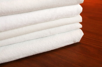 Folded white bed linen